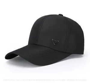 Close-up of black baseball cap featuring a triangular metal logo and breathable fabric