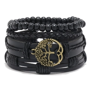 Detail of multi-layer handmade black leather bracelets with bronze tree of life charms