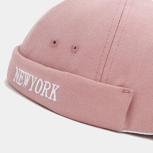 Macro shot of NEW YORK embroidery on dusty pink cotton canvas docker hat with eyelets