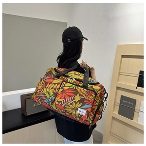 Detail of printed travel tote bag with leaf pattern shown on model in a modern room