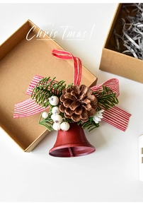 Detail of red metal Christmas bell with pine cones, green needles and festive bow