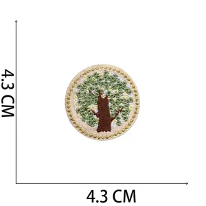 Macro detail of round tree embroidery patch with gold border measuring 4.3cm and weighing 1.1g