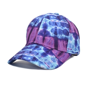 Macro detail of tie-dye pattern on blue and purple cotton canvas baseball cap