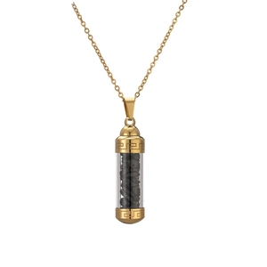 Detail of golden cylinder perfume pendant necklace with black crushed stones and Greek keys