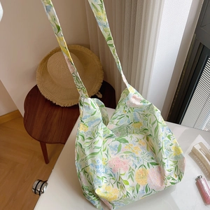 Detail of floral cotton tote bag in French country style on a sunlit wooden table