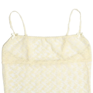 Close-up of pale yellow lace camisole featuring delicate patterns and small bow details