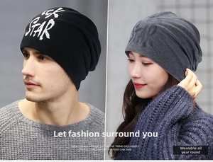 Close-up of black and grey slouchy beanies with STAR letter print on knit fabric