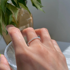 Close-up of minimalist silver plated adjustable chain ring with fine pave diamonds on finger
