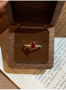 Détail d'une bague plaquée or 18 carats avec gourde rouge et zircons étincelants