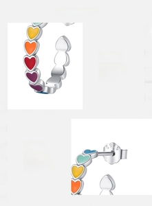 Macro detail of S925 sterling silver colorful enamel heart earrings with fine polish
