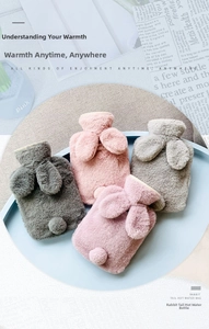 Fluffy rabbit ear hot water bottles in various pastel colors displayed on a tray