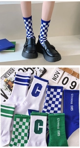 Detail of checkerboard and embroidered athletic crew socks in retro American style