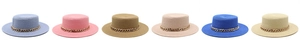 Detailed view of woven flat top straw hats with gold chain accents in various colors