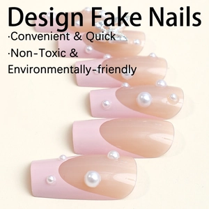 Pink and tan French design fake nails with pearl accents and a 3D butterfly accessory