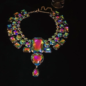 Macro detail of faceted AB coating iridescent crystal necklace with gold link chain