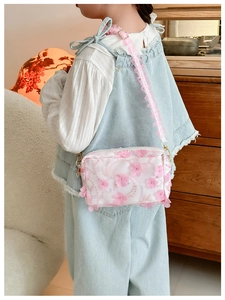Detail of floral girls crossbody bag with 3D pink flower, sequins and lace strap