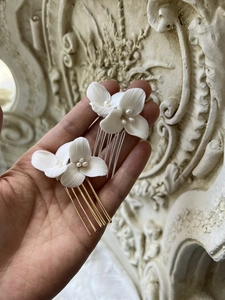 Detailed close-up of white ceramic flower hair comb with freshwater pearls for bridal