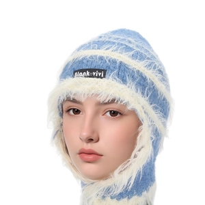 Close-up of soft blue and white plush knit trapper hat with authentic brand label