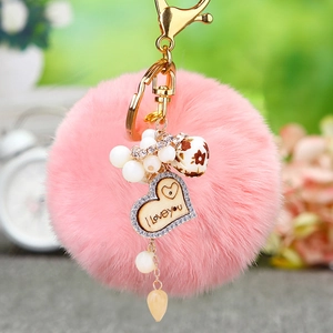 Porte-clés en fausse fourrure rose avec cœur en bois, strass et perles fleuries sur doré