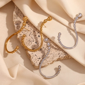 Minimalist 18K gold and silver plated stainless steel drop earrings on stone background