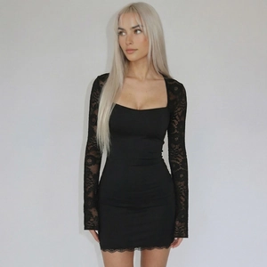Detail of elegant black bodycon dress featuring lace sleeves and a stylish square neckline
