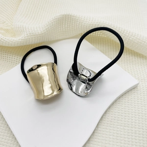 Close-up of gold and silver irregular alloy hair ties with black elastic bands