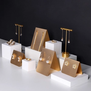 Detailed view of golden jewelry display stand set with elegant earrings and rings