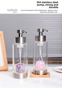 Detailed view of glass lotion bottle with 304 stainless steel pump and natural crystal stones