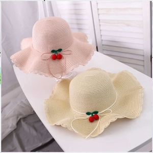 Kids woven straw sun hat with cherry accents and wavy lace edges in pink and beige