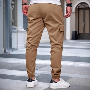 Men's khaki jogger cargo pants featuring side pockets and a tapered outdoor street style