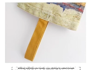 Detail view of the wide canvas handle with reinforced cross stitching on the Van Gogh bucket bag
