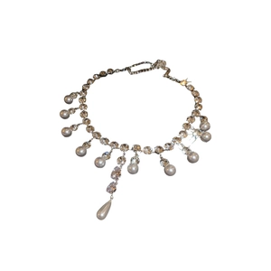 Elegant pearl and teardrop zircon necklace with crystal chain on a white background