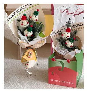 Detail of Christmas flower packaging paper with plush snowmen and festive pine needles