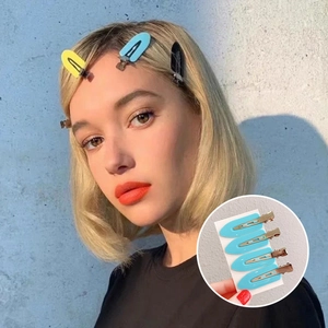 Close-up of colorful seamless hair clips in yellow, blue and black for hairstyling