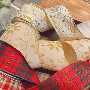 Macro view of Christmas ribbons with gold snowflake prints and red green plaid fabric