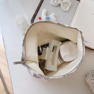 Internal view of floral cotton makeup bag showing spacious storage for cosmetics