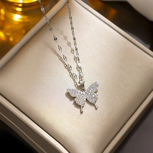 Silver bowknot pendant necklace with sparkling cubic zirconia on a wavy chain