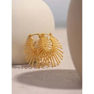 Macro detail of 18k gold fan-shaped stainless steel earrings with sparkling crystals