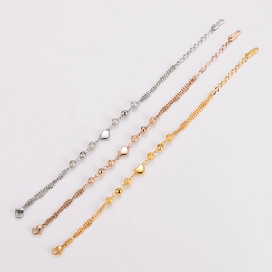 Three-tone stainless steel beaded bracelets with heart charms in gold, silver, and rose gold