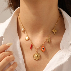 Gold stainless steel paperclip necklace with shell elephant heart and papaya charms on model