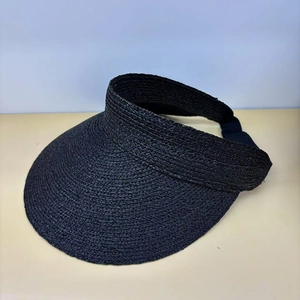 Detailed side view of black wide-brimmed raffia sun visor with elastic strap for women