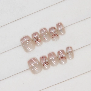 French cat eye press-on nails with red bows and polka dots on pink base, 10 piece set
