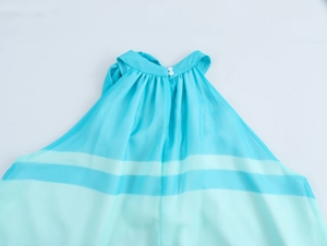 Detail of lake blue striped chiffon halter dress featuring neckline pleats and small buttons