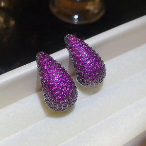 Macro shot of teardrop earrings featuring rose red pavé zircon stones on black metal base