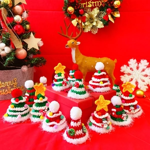 Macro detail of hand-knitted mini Christmas hats for pets with festive decorations