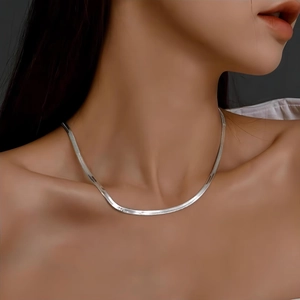Polished silver titanium steel flat snake chain necklace worn on model neck