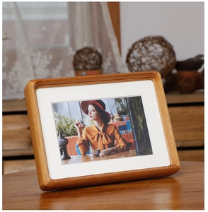 Detailed view of walnut photo frame with smooth rounded corners and natural wood grain