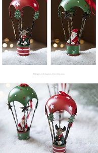 Close-up of iron Christmas hot air balloon ornaments with Santa and reindeer dolls