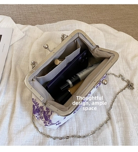 Detail view of floral lace evening bag interior with compartments and silver chain strap