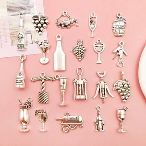 Detailed set of 21 silver alloy wine charms including bottles, glasses, and openers